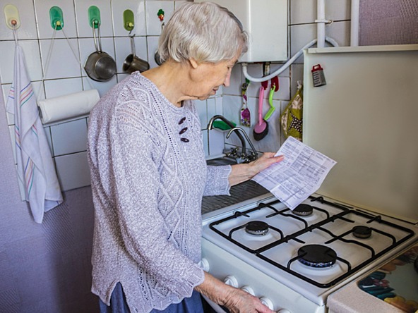 Older lady examining  gas/electric bill with concern